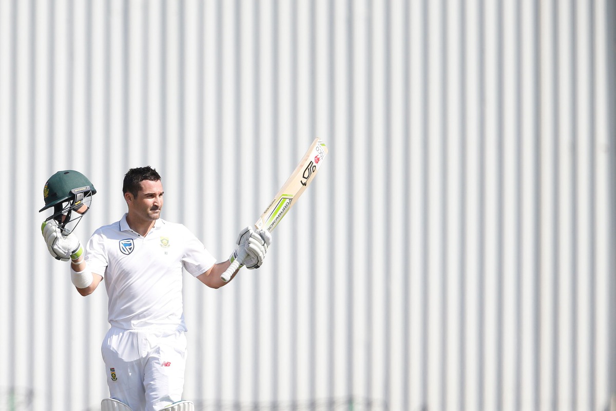 South African batsman Dean Elgar raises his bat and helmet as he celebrates scoring a century (100 Runs) during the first day of the first Test Match between South Africa and Bangladesh on September 28, 2017 in Potchefstroom, South Africa.  AFP / Gianluig