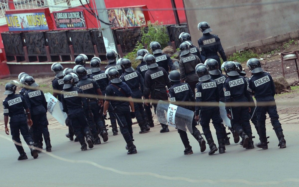 Cameroon police officials walk with riot shields on a street in the administrative quarter of Buea some 60kms west of Douala on October 1, 2017.  AFP
