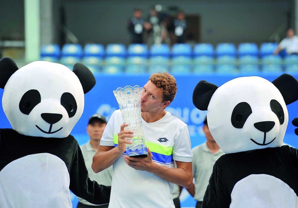 Uzbekistan’s Denis Istomin poses with the trophy after defeating Cyprus’ Marcos Baghdatis during their men’s singles final at the ATP Chengdu Open in Chengdu, yesterday. 