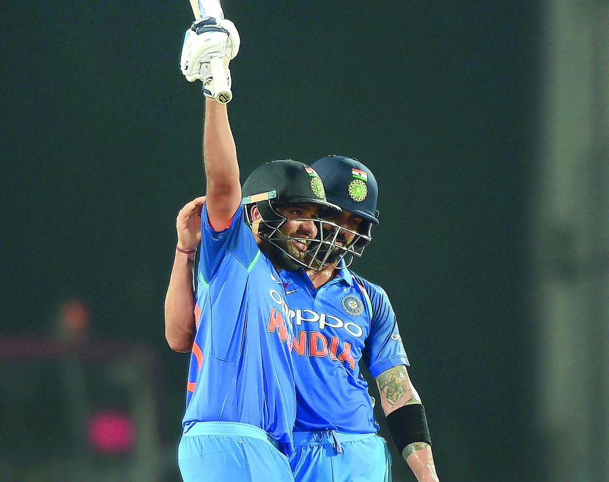 India’s Rohit Sharma (left) celebrates after scoring a century as captain Virat Kohli watches during the fifth one-day international match against Australia at the Vidarbha Cricket Association Stadium in Nagpur, yesterday.