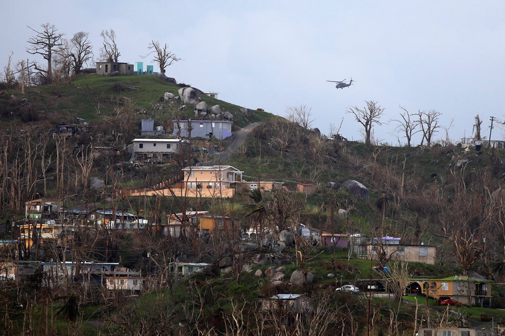 A military helicopter flight over a residential area following damages caused by Hurricane Maria near Caguas, Puerto Rico, October 1, 2017 REUTERS/Carlos Barria
