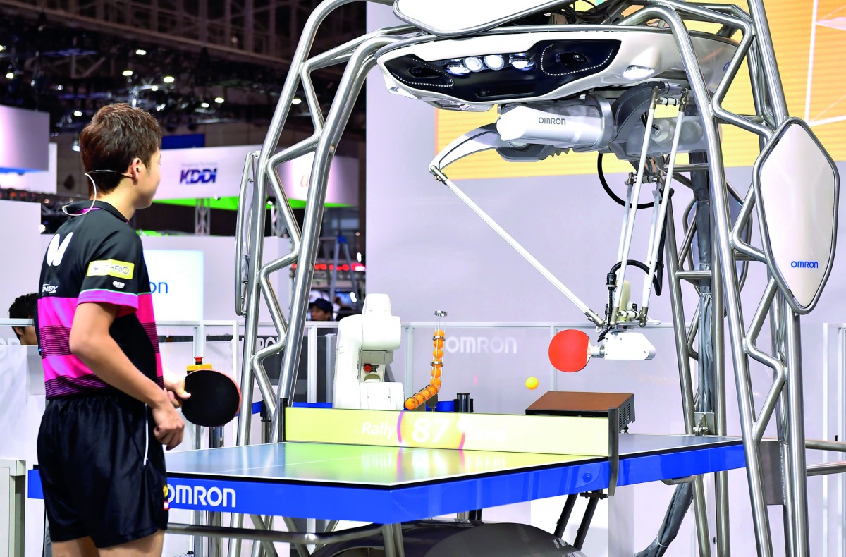 FORPHEUS, a fourth-generation table-tennis robot developed by automation parts maker Omron, returns a shot to a human player during a press preview at the Combined Exhibition of Advanced Technologies (CEATEC) Japan in Chiba, suburban Tokyo on October 2, 2