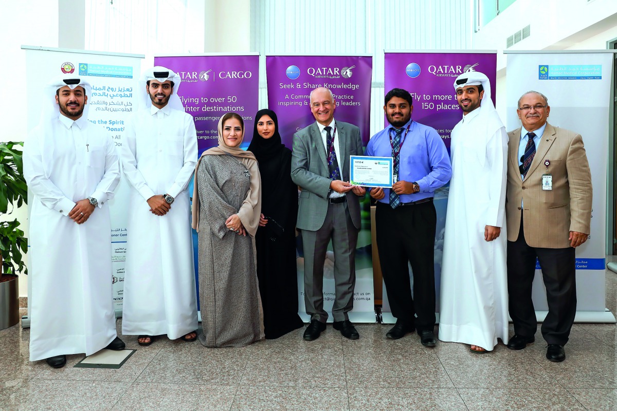 Qatar Airways and Hamad Medical Corporation (HMC) officials pose for a group picture.