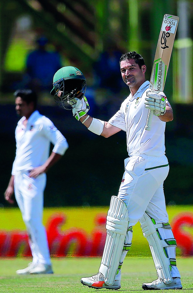 South Africa’s Dean Elgar raises his bat as he celebrates his century during the first day of the second Test match against Bangladesh in Bloemfontein yesterday.