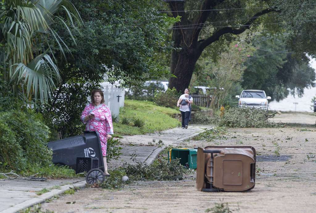 Biloxi residents venture out just after dawn to survey the damage after the eye of Hurricane Nate made its second landfall on October 8, 2017 in Biloxi, Mississippi.  Mark Wallheiser/AFP
