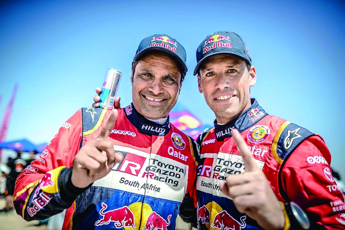 Qatar’s Nasser Saleh Al Attiyah (left) and his French navigator Matthieu Baumel gesture after victory in Morocco yesterday.