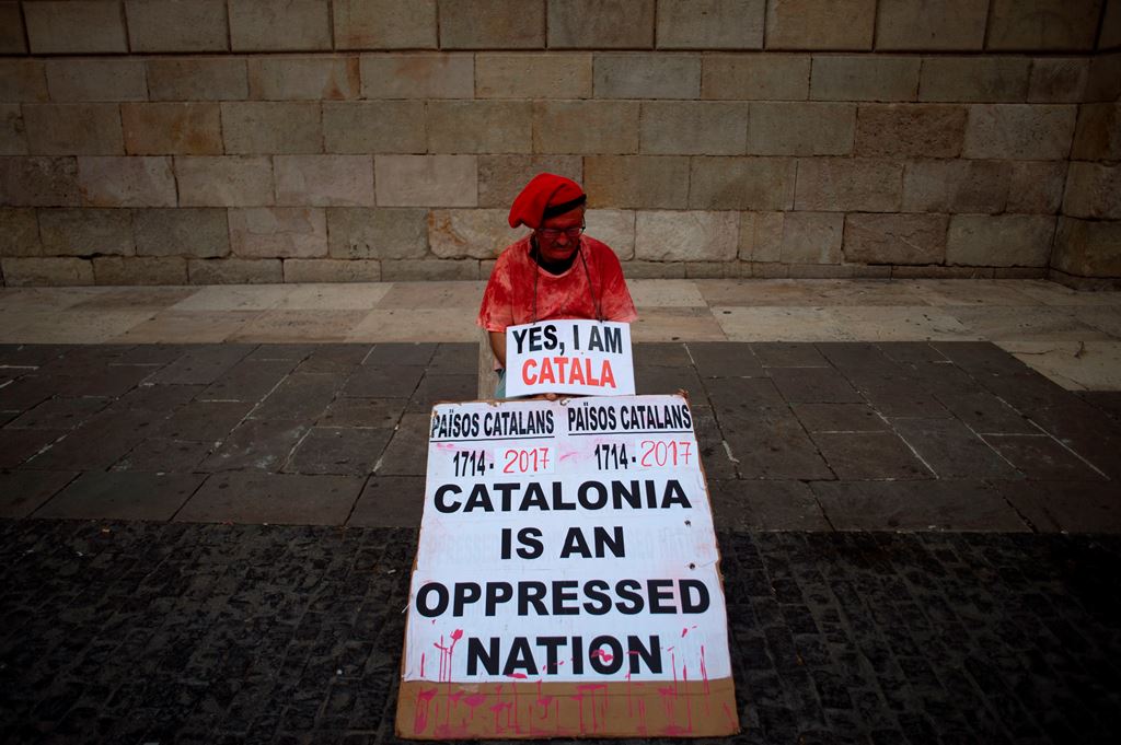 A man holds a placard reading 