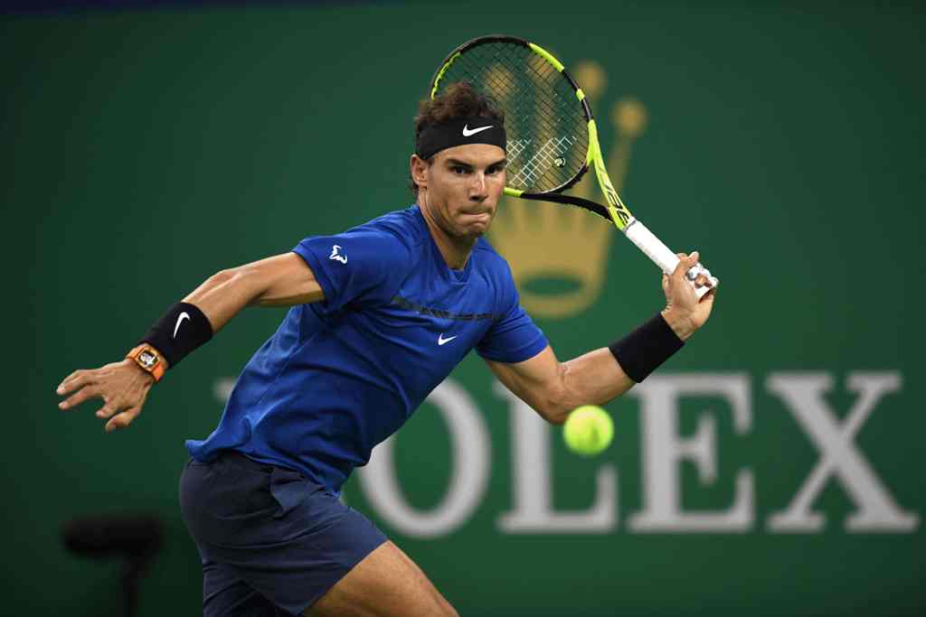 Rafael Nadal of Spain hits a return during his men's 2nd round singles match against Jared Donaldson of the US at the Shanghai Masters tennis tournament in Shanghai on October 11, 2017. / AFP / NICOLAS ASFOURI