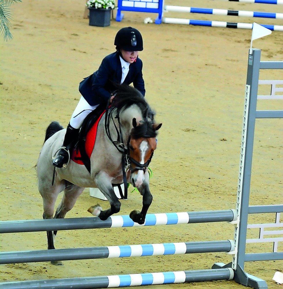 A young rider competes during the opening round of Hathab at Al Shaqab’s Indoor Arena on Saturday. 