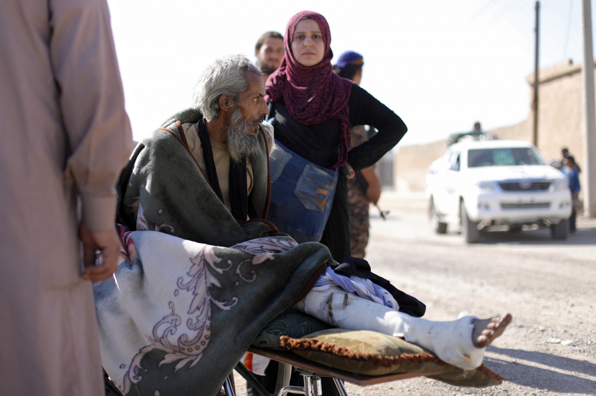 A wounded man lies on a stretcher as he flees Raqqa, Syria October 16, 2017. Reuters/ Rodi Said