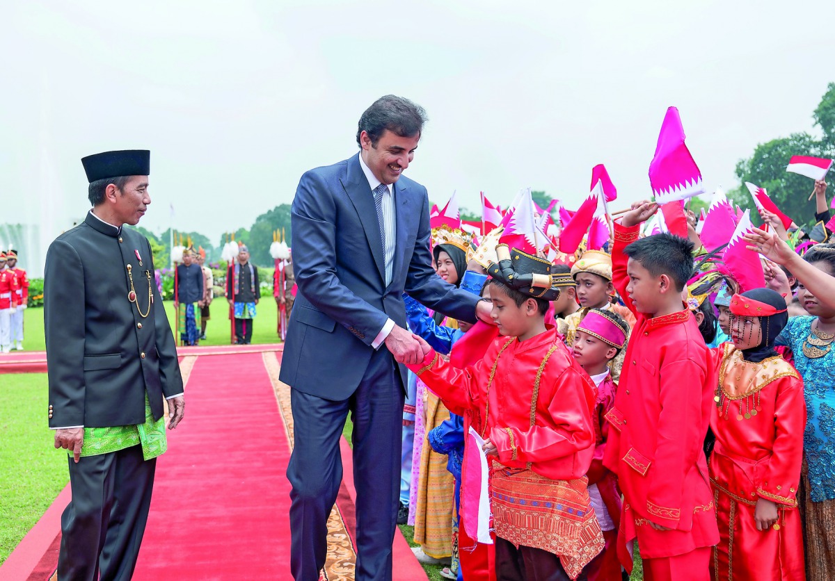 Emir H H Sheikh Tamim bin Hamad Al Thani shaking hands with children as the President of the Republic of Indonesia, Joko Widodo looks on, in Jakarta yesterday.
