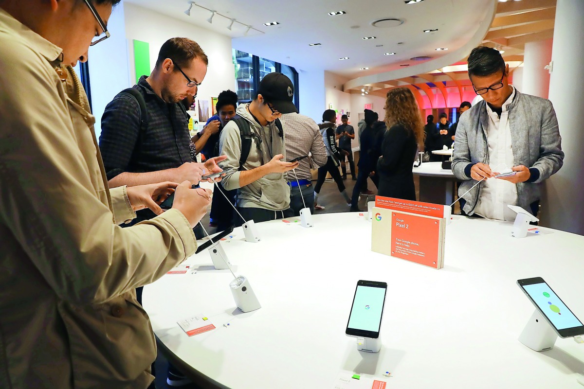 People look at Google's new Pixel 2 phones at a New York City pop-up shop on October 19, 2017 in New York City. The temporary store in the Flatiron neighborhood of Manhattan sells and demonstrates such Google products as the new Pixel 2 phone, home speake