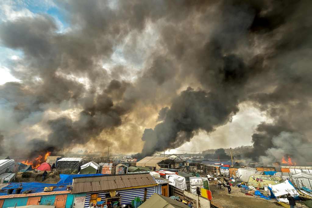 This file photo taken on October 26, 2016 shows smoke rising from a fire over the 
