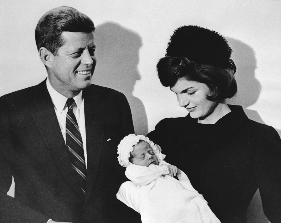 This December 10, 1960, file photo shows John F. Kennedy and his wife Jacqueline holding their son John during the christening ceremony at the chapel of Georgetown University in Washington, DC. / AFP / SAM SCHULMAN