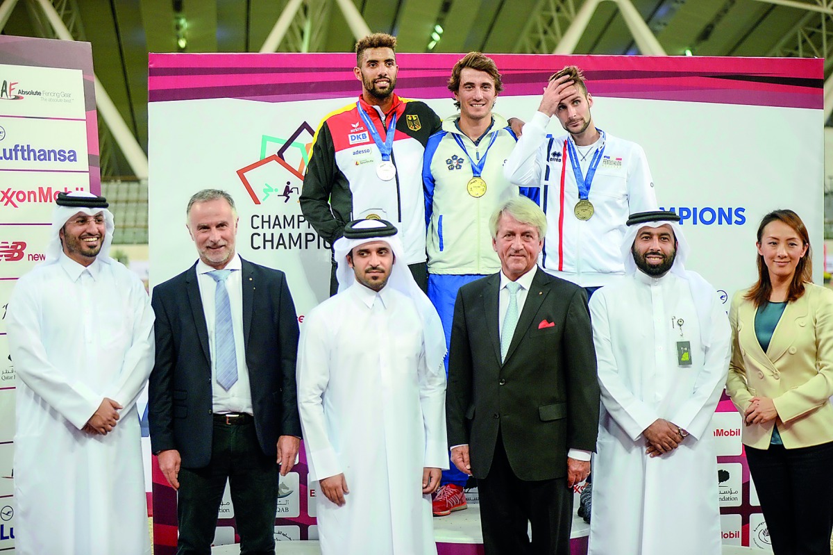 The podium winners, Italian penathlete Riccardo De Luca, Patrick Douge of Germany and France’s Valentin Belaud pose for a photograph with officials of Qatar Equestrian Federation and International Modern Pentathlon Federation (UIPM) during the prize distr