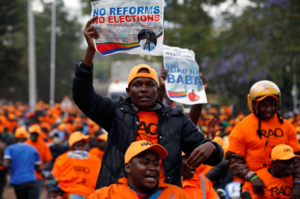 Supporters of Kenyan opposition leader Raila Odinga carry banners during a rally at Uhuru Park in Nairobi, Kenya October 25, 2017. REUTERS/Siegfried Modola