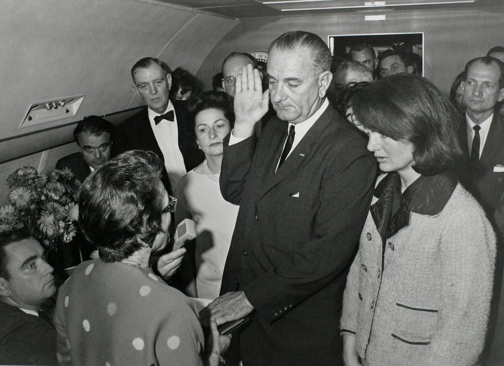A file photo of US Vice President Lyndon Baines Johnson (C) takes the presidential oath of office from Judge Sarah T. Hughes (2nd from L) as President John F. Kennedy's widow first lady Jacqueline Bouvier Kennedy (2nd from R) stands at his side aboard Air