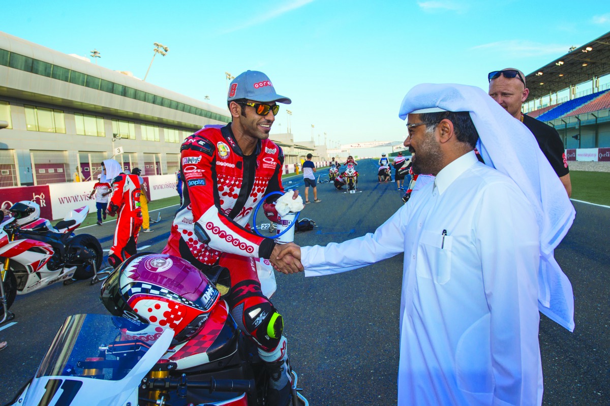 Qatari rider Saeed Al Sulaiti is congratulated by Qatar Motor and Motorcycle Federation (QMMF) President Abdulrahman Al Mannai at the Losail Circuit in Doha ahead of the WorldSBK Championship.