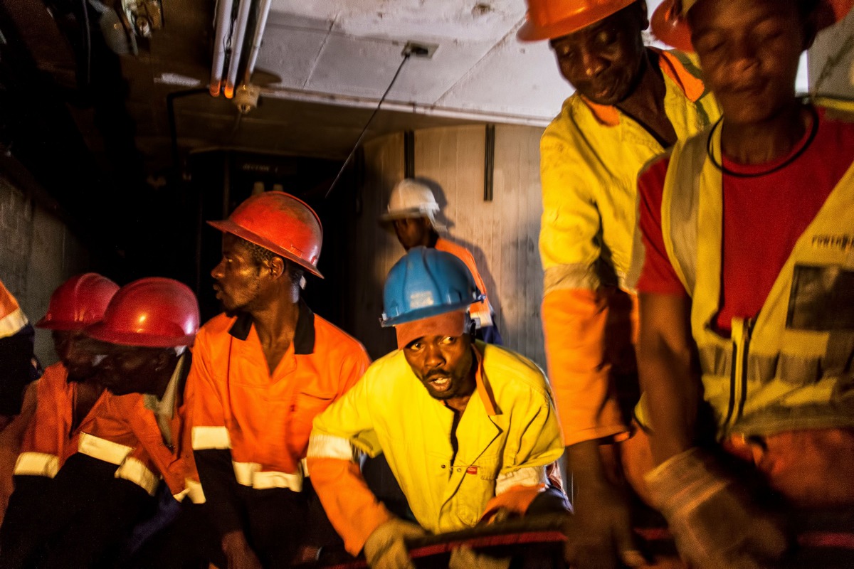 City Power contractors working underground in Johannesburg, South Africa pull through new power cabling as it is fed to them from an above ground site on September 8, 2017. AFP / Tadeu Andre