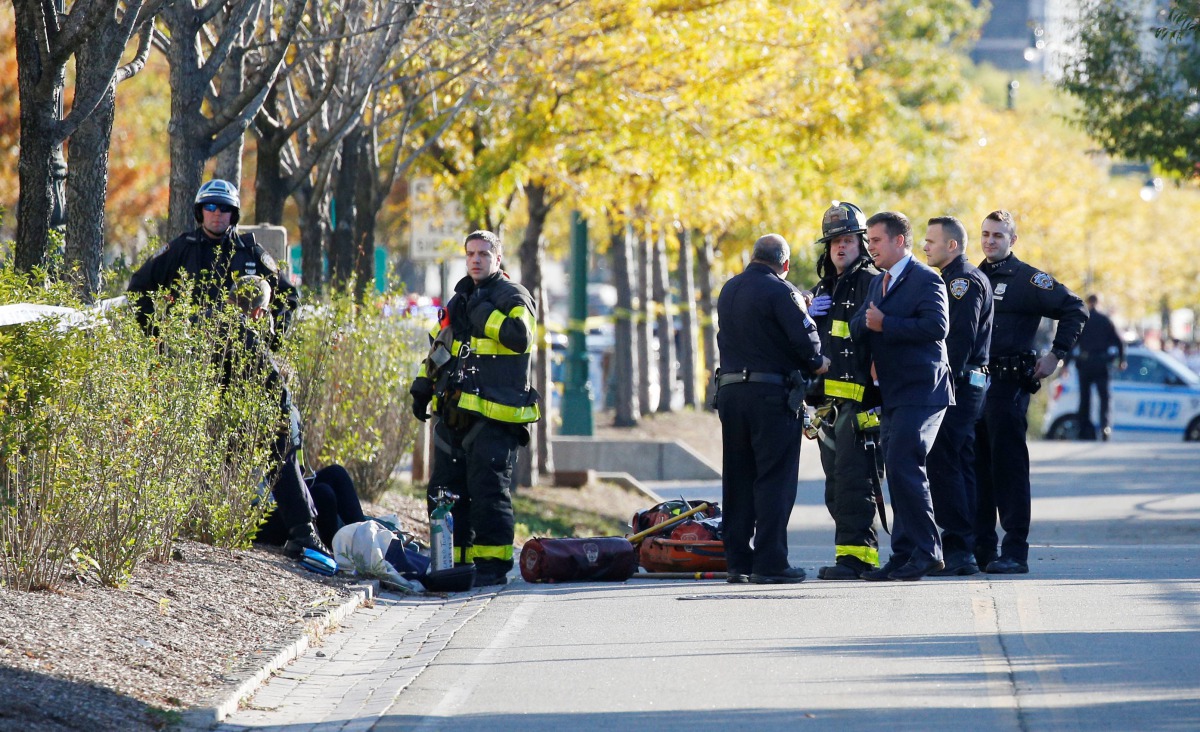 New York city first responders stand at the crime scene on a bike path in lower Manhattan in New York, NY, U.S., October 31, 2017. Reuters/Brendan McDermid