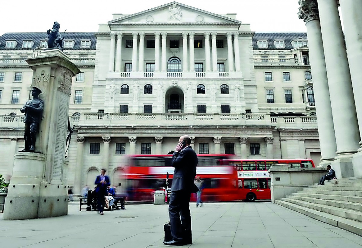 A man talks on a mobile phone as people walk past the Bank of England, in London, Britain September 21, 2017. Reuters/Mary Turner
