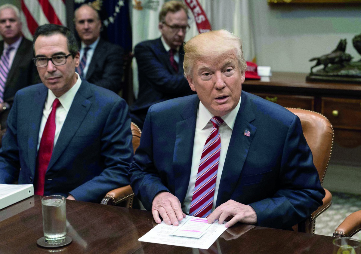 US President Donald Trump speaks at a meeting with business leaders on tax reform at the White House in Washington, DC, on October 31, 2017. On left, is Treasury Secretary Steve Mnuchin. AFP / Nicholas Kamm