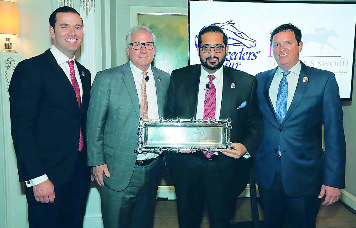 Qatar Racing and Equestrian Club (QREC) General Manager, Nasser bin Sherida Al Kaabi poses for a photograph with Breeders Cup Officials.