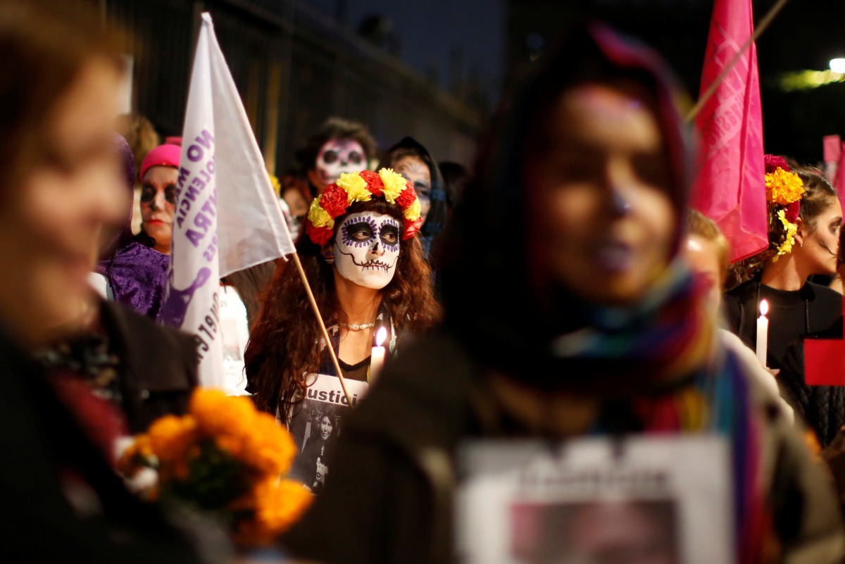A file photo of activists with faces painted to look like the popular Mexican figure 