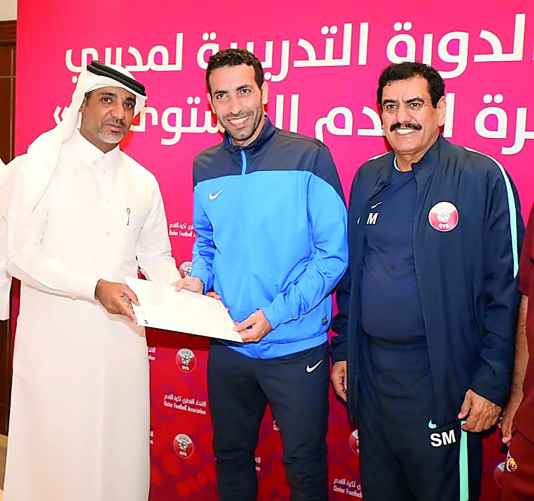Fahad Thani Al Zaraa, Director of the Development Department at QFA, giving away certificate to a participant in Doha yesterday. 
