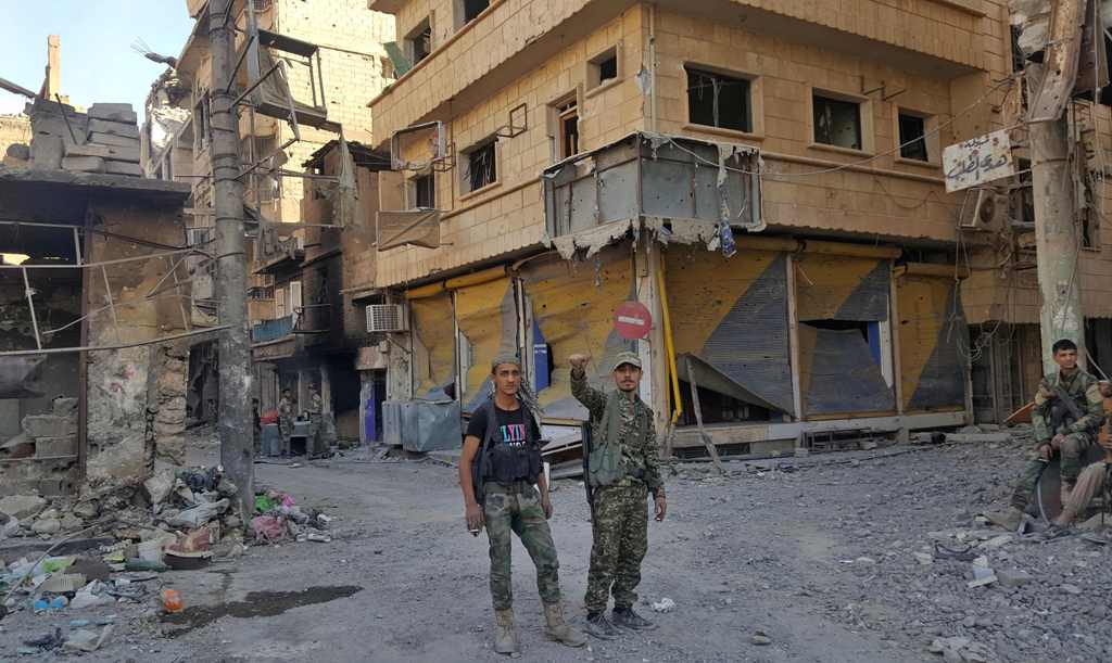 A file photo of Syrian government forces are pictured in the eastern Syrian city of Deir Ezzor on November 3, 2017. / AFP / STRINGER