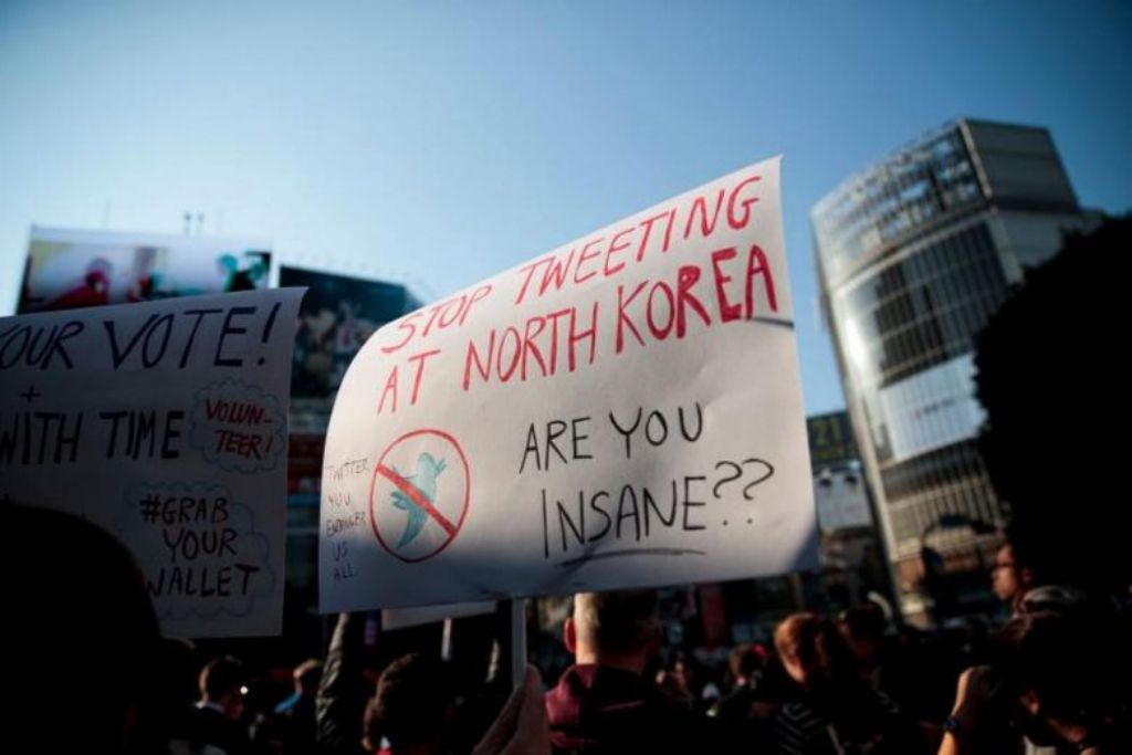 US residents in Japan display placards during a demonstration against US President Donald Trump in Tokyo on Nov 5, 2017. PHOTO: AFP.