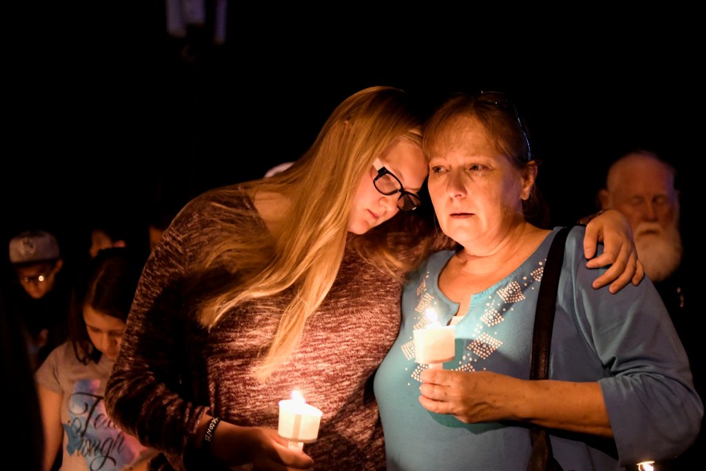 Local residents embrace during a candlelight vigil for victims of a mass shooting in a church in Sutherland Springs, Texas, U.S., November 5, 2017. REUTERS/Mohammad Khursheed