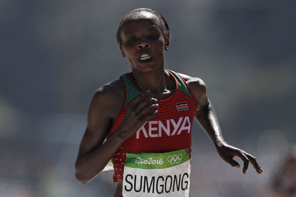 (FILES) This file photo taken on August 14, 2016 shows Kenya's Jemima Jelagat Sumgong running on her way to win the Women's Marathon during the athletics event at the Rio 2016 Olympic Games at Sambodromo in Rio de Janeiro. AFP / Adrian DENNIS

