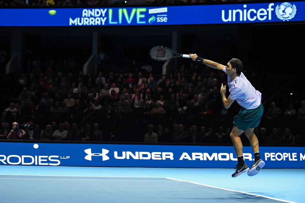 Switzerland's Roger Federer returns to Britain's Andy Murray in their exhibition tennis singles match, during 