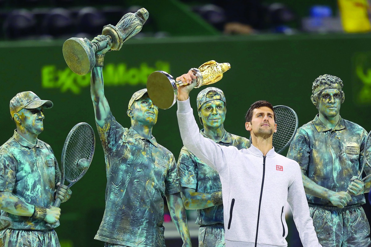 Serbian Novak Djokovic poses with the 2017 ExxonMobil Qatar Open trophy at the Khalifa International Tennis Complex in Doha in this file photo