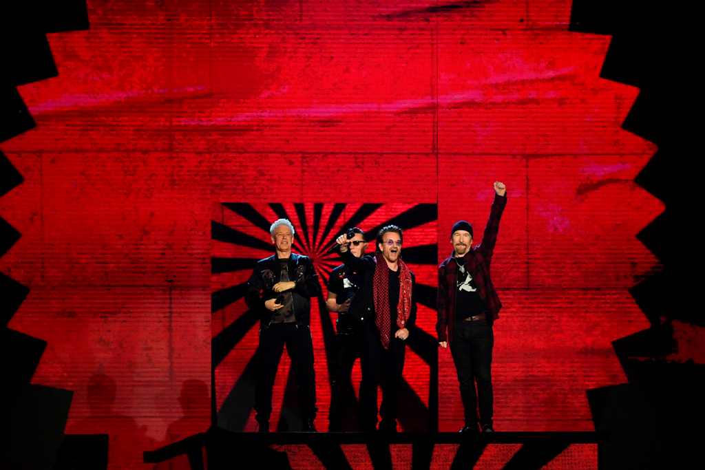 An image of Irish rock band U2, Bono (2R), The Edge (R), Adam Clayton (L) and Larry Mullen Jr (2L), accept the global icon award during the 2017 MTV Europe Music Awards (EMA) at Wembley Arena in London on November 12, 2017. / AFP / Ben STANSALL