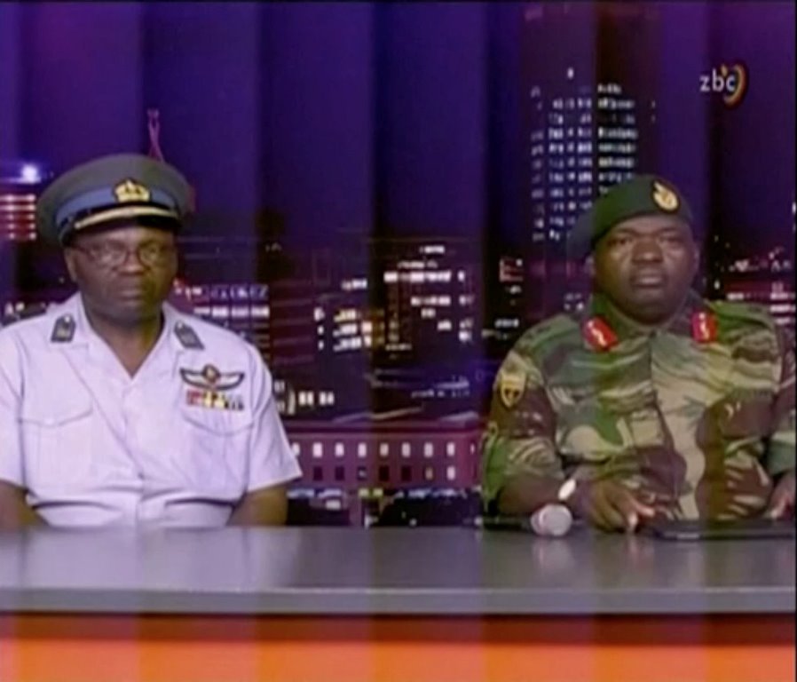 Zimbabwe Defence Forces Major-General SB Moyo (R) makes an announcement on state broadcaster ZBC, in this still image taken from a November 15, 2017 video. ZBC/Handout via REUTERS 