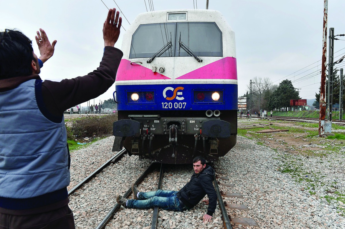 FILE PHOTO: Migrants protest at Greece-Macedonia border (AFP) 