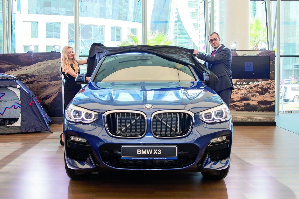 Ma’n Alhamawi (right), COO of Alfardan Automobile, unveiling the all-new BMW X3 before the media yesterday at BMW West Bay showroom.