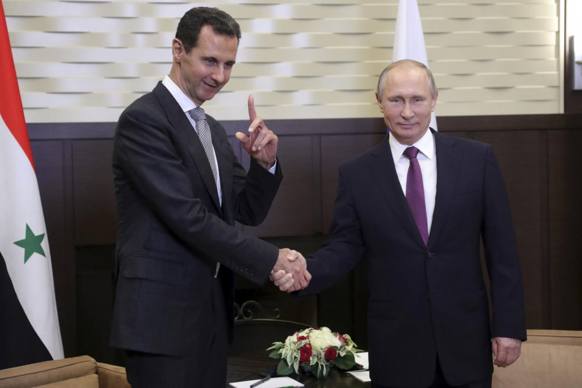 Russian President Vladimir Putin (R) meets with Syrian President Bashar al-Assad in the Black Sea resort of Sochi, Russia November 20, 2017. Sputnik/Mikhail Klimentyev/Kremlin via REUTERS
