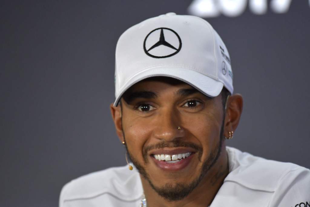 Mercedes' British driver Lewis Hamilton gestures during the drivers press conference ahead of the Abu Dhabi Formula One Grand Prix at the Yas Marina circuit on November 23, 2017.  AFP / GIUSEPPE CACACE
