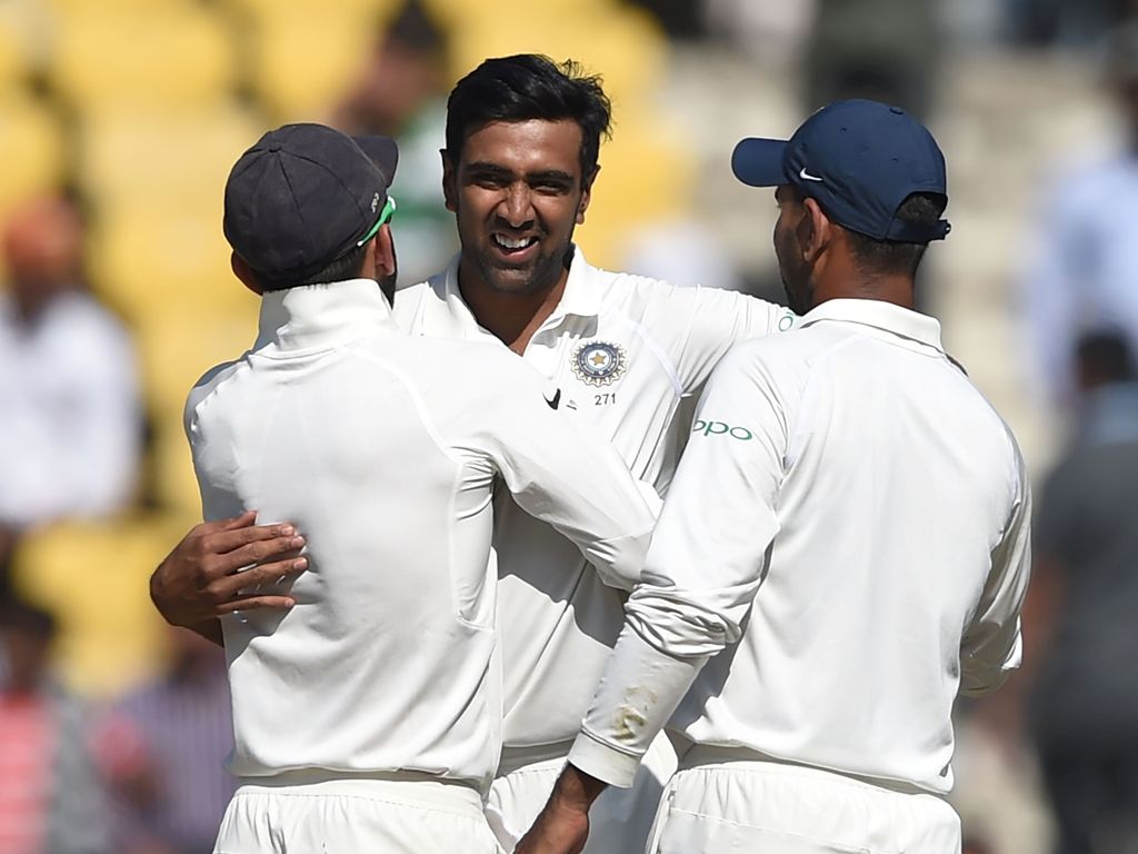 Indian cricketer Ravichandran Ashwin (C) celebrates with captain Virat Kohli (L) after India won the second Test cricket match against Sri Lanka at the Vidarbha Cricket Association Stadium in Nagpur on November 27, 2017. / GETTYOUT/ AFP / PUNIT PARANJPE /