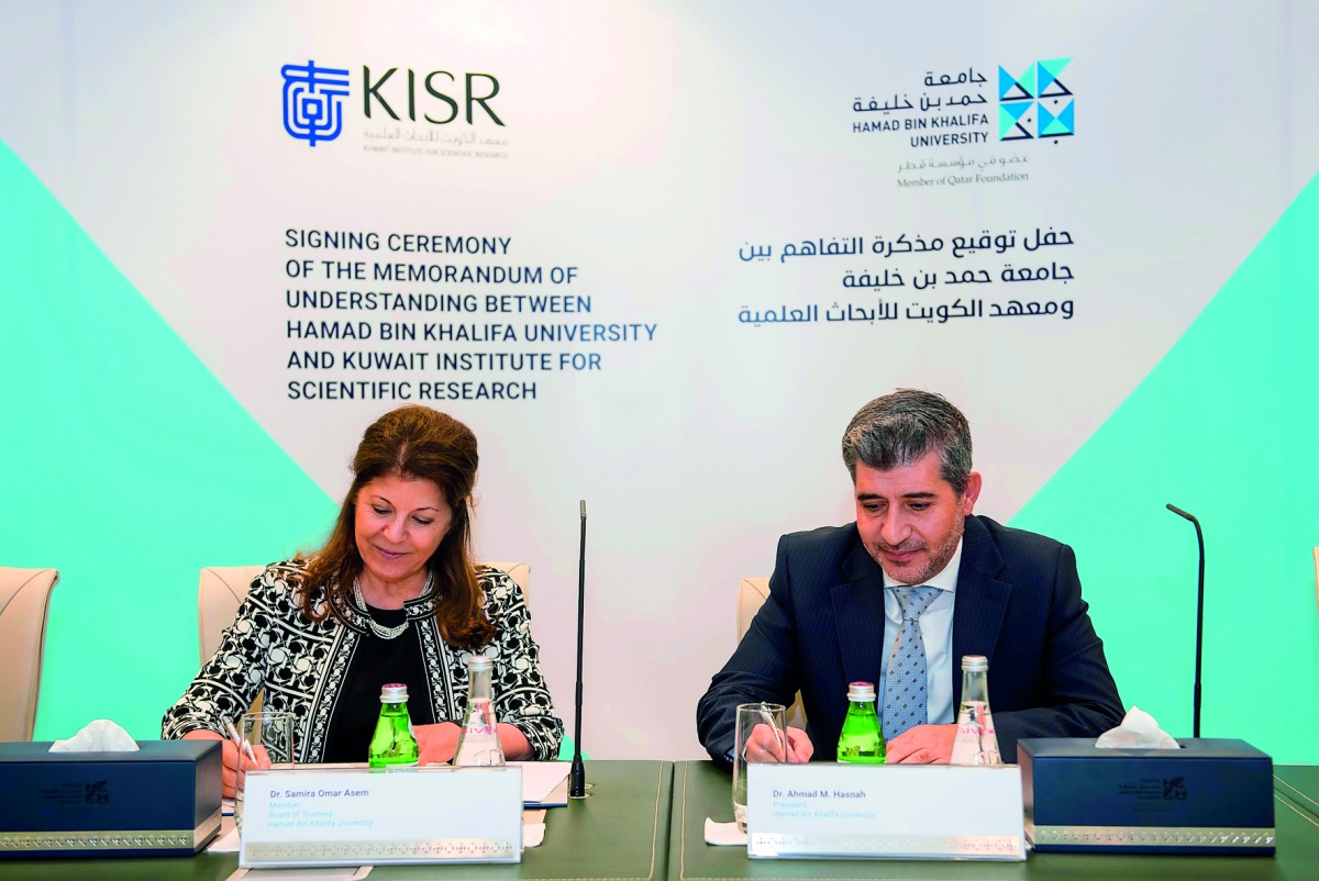 Dr. Ahmad M Hasnah, President of HBKU and Dr. Samira Omar, Director-General of KISR,  sign the agreement. 
