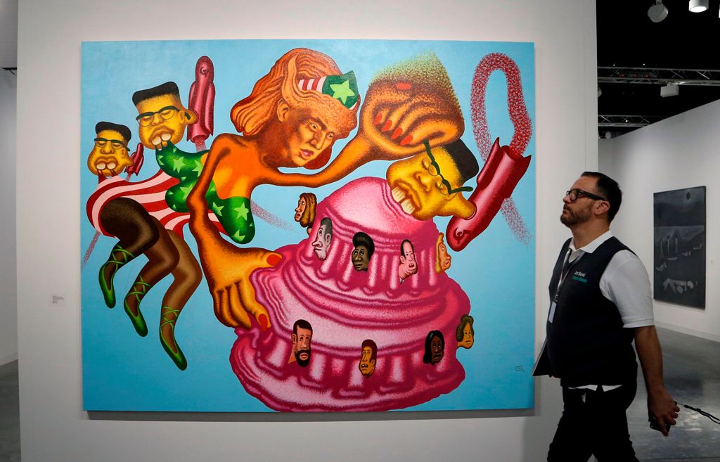 An Art Basel patron walks past 