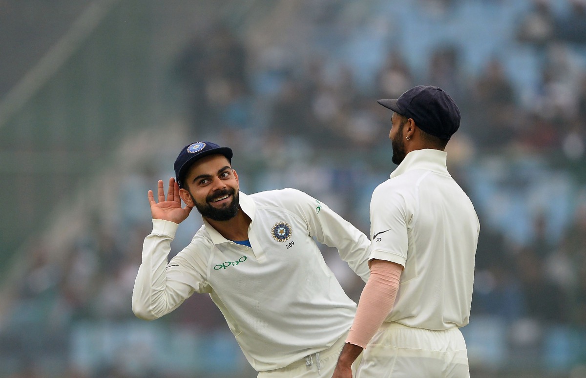 (FILES) This file photo taken on December 5, 2017 shows Indian team captain Virat Kohli (L) gesturing towards the crowd as teammate Shikhar Dhawan looks on during the fourth day of third Test cricket match between India and Sri Lanka at the Feroz Shah Kot