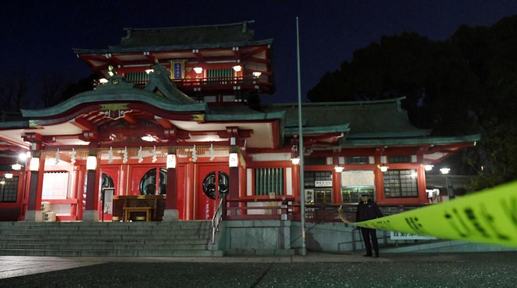 A policeman stands guard in front of Tokyo's Tomioka Hachiman shrine after three people died in an apparent murder-suicide on December 8. Kyodo/via Reuters 