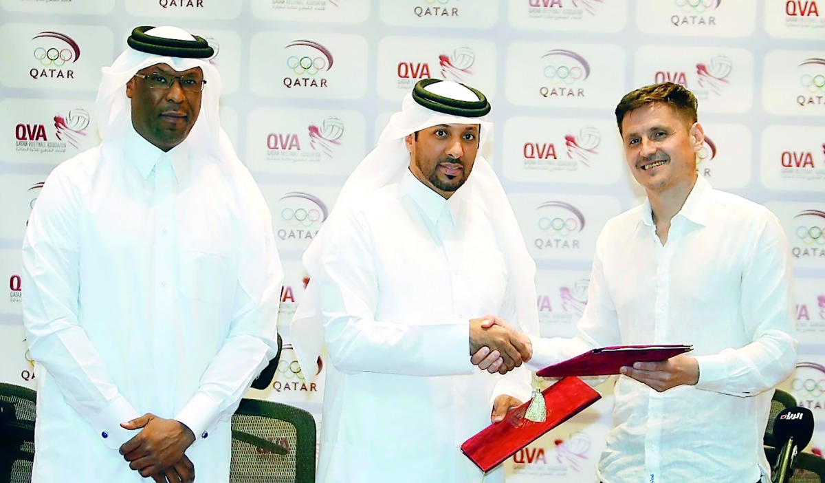 Camilo Soto of Argentina, the new Qatar volleyball coach, shakes hands with President of Qatar Volleyball Association (QVA) Ali bin Ghanim Al Kuwari during a press conference in Doha yesterday. QVA Board Member Mubarak Eid Al Abdullah was also present. 