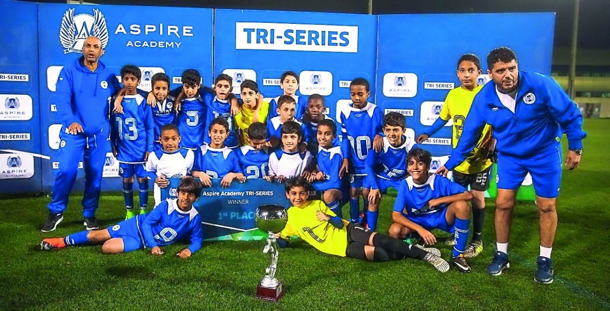 Aspire Academy players and officials celebrates during the prize distribution ceremony after winning the Tri-Series football tournament in Doha.