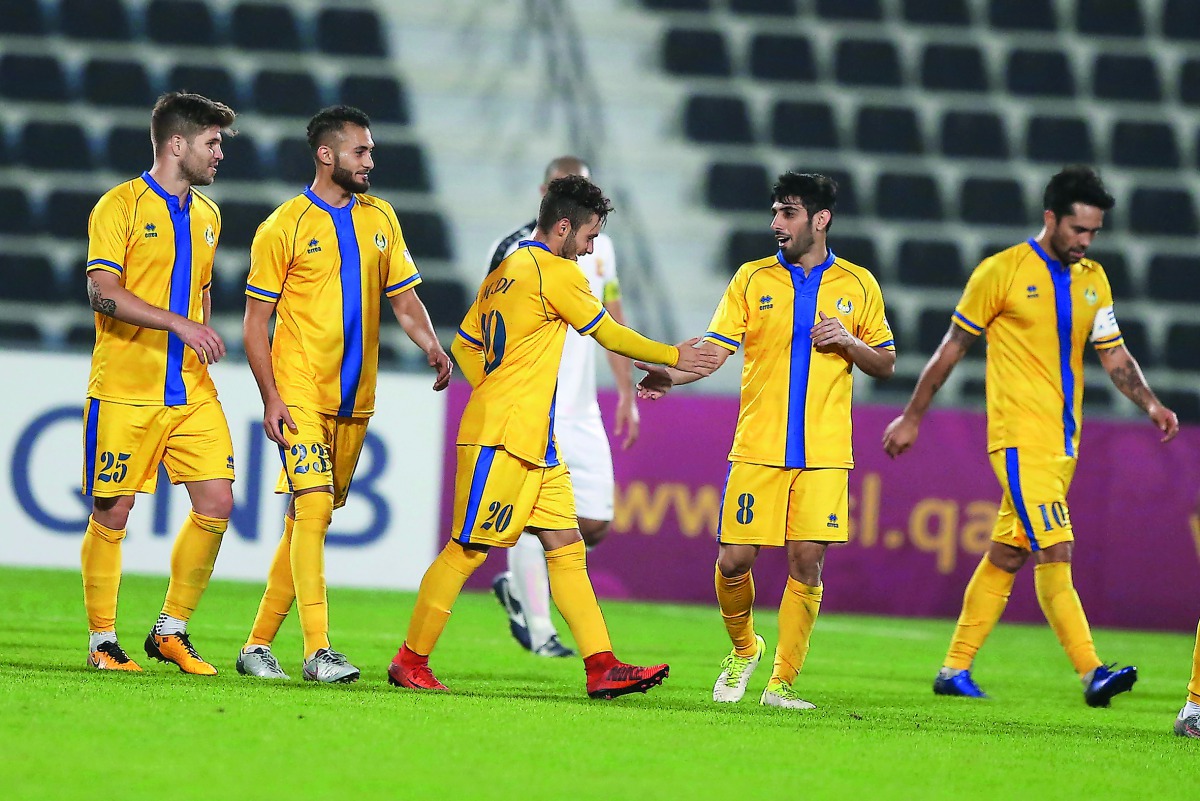 Al Gharafa players celebrate after scoring a goal against Umm Salal yesterday.