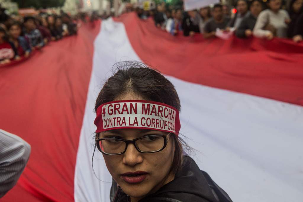 People protest against Fujimorism and corruption in Lima on December 16, 2017, as the presidency of Pedro Pablo Kuczynski hangs in the balance while the opposition, which controls Congress, demands he steps down or face impeachment over graft allegations 